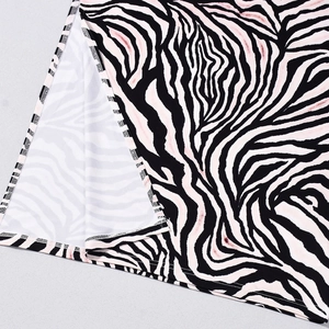Close-up of zebra print dress featuring side slit design and subtle pink hue accents