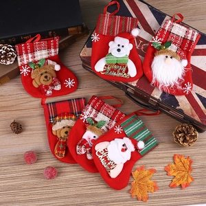 Group of festive felt Christmas stockings featuring 3D Santa, bear, and snowman characters