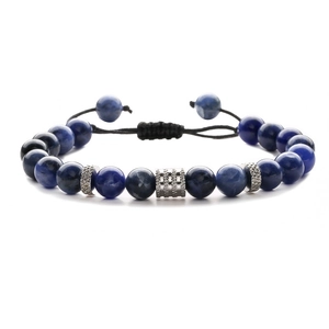 Detail of adjustable braided cord bracelet with blue marble beads and steel spacers
