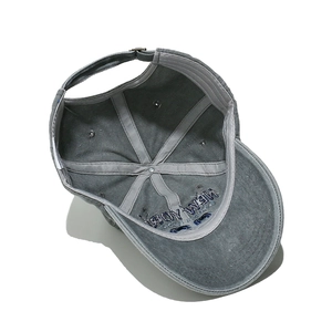 Detail of internal lining, reinforced seams, and adjustable metal buckle on baseball cap