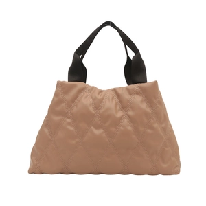 Dusty pink quilted puffer tote bag with black woven handles and diamond stitch pattern