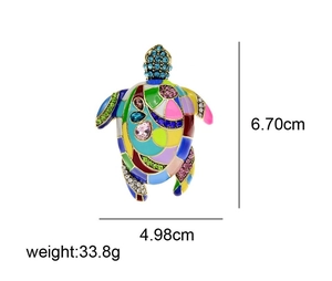 Detail view of turtle brooch showing colorful enamel segments and sparkling rhinestones