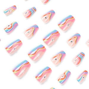 Press-on nails featuring pastel wave patterns, white flowers and small rhinestones