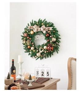 Détail d'une couronne de Noël avec lumières LED, renne doré et signe Joyeux Noël