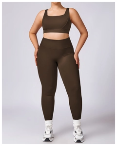 Close-up of high-waisted dark brown yoga leggings and sports bra set in premium matte fabric