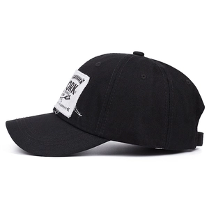 Classic black cotton baseball cap with white New York vintage patch on a white background