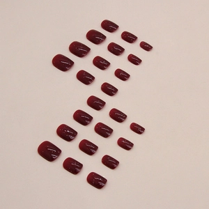 Deep wine red glossy short square-oval press-on nails set with 24 pieces on pink background