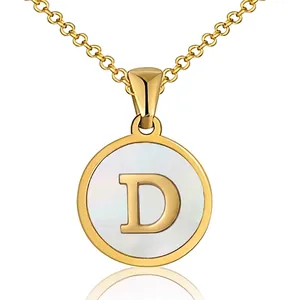 Detailed close-up of a round gold letter D pendant with white mother-of-pearl inlay and O-chain