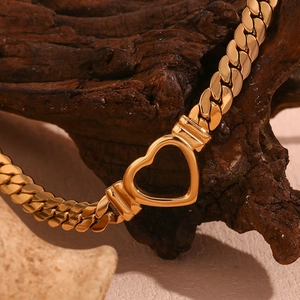 Detail of 18K gold plated heart toggle clasp and Cuban link chain with mirror finish