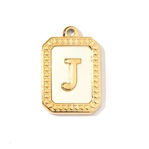 Detailed macro view of a vintage gold and white rectangular pendant featuring the letter J