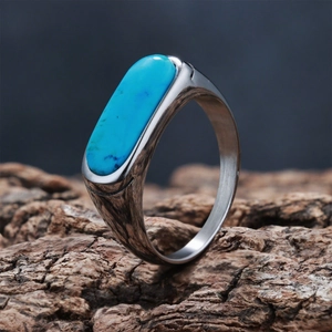 Macro detail of vintage silver ring with oval blue turquoise stone on rustic wood