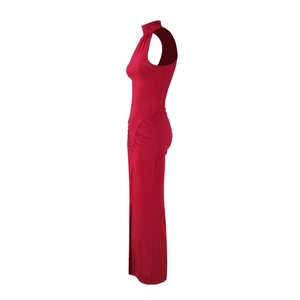 Detail of red bodycon maxi dress featuring side ruching and elegant high neck slit