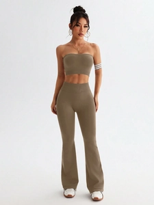 Detail of high-waist flared yoga pants and crop top set in earthy brown knit fabric