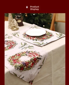 Detail of Christmas table runner and placemats with holly wreath and festive red bows