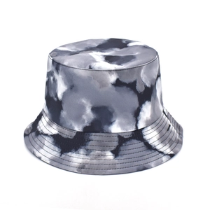 Detail of a tie-dye bucket hat featuring grey marble pattern and reinforced brim stitching