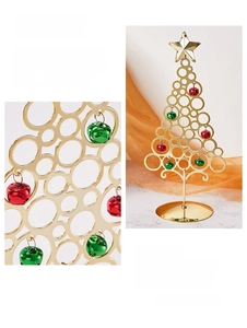 Detail of golden iron Christmas tree with colorful bells and top star on orange silk