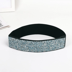Close-up of wide elastic belt featuring shiny blue and silver glitter sequin texture