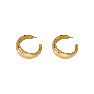 Elegant gold-tone wide C-shaped hoop earrings with a polished metallic finish on white background