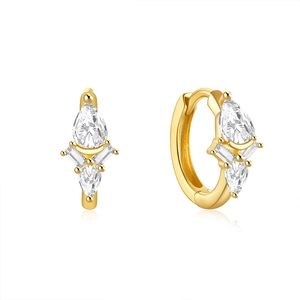 Macro shot of gold-plated silver earrings with teardrop and baguette-cut zircons