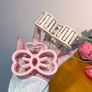 Matte resin bow and wave shark hair clips in sweet pink and beige colors