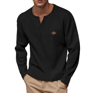 Detail of men's waffle knit Henley shirt with button neckline and small leather patch