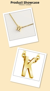 Close-up of polished gold-plated letter M and K pendants with elegant O-chains