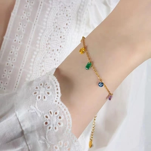 Rainbow cubic zirconia 18K gold plated titanium steel bracelet worn on a female wrist
