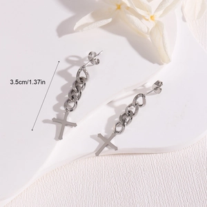 Detail shot of silver cross chain earrings with 3.5cm length measurement guide