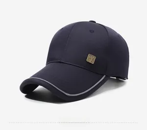 Close-up of navy blue baseball cap featuring a vintage metal logo and reflective brim edge
