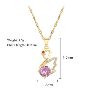 Close-up of golden swan pendant with pink gemstone and crystals, 40+5cm chain detail