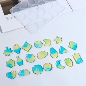 Macro view of flower and geometric resin earring molds with clear gradient pendant samples