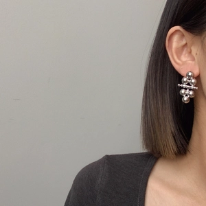 Minimalist silver spherical drop earrings featuring a polished metallic bead design