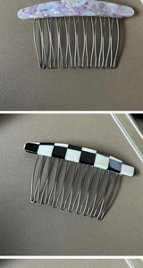Close-up of purple marble and checkerboard acetate hair combs with metal teeth