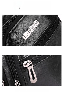 Detail of first layer cowhide texture with silver zipper and metal logo on black chest bag