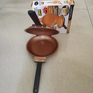 Unfolded copper non-stick pancake pan with original box featuring titanium ceramic coating