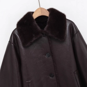 Women's dark brown faux leather jacket with plush shearling collar on wooden hanger
