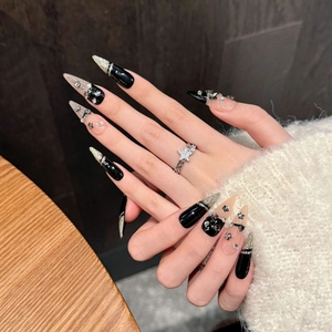 Handmade black stiletto press-on nails with silver glitter stripes and star accents