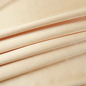 Detail of luxurious champagne satin fabric with elegant velvet texture and soft glossy sheen