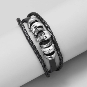 Men's punk leather bracelet with silver metal skull charm on a black woven cord
