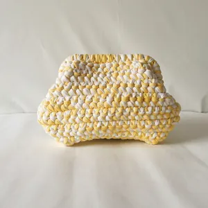 Handmade crochet cloud bag in yellow and white color block with metal frame clasp