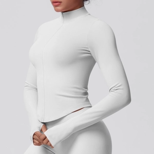 Detail of white slim fit sports jacket with thumb holes and zipper collar for yoga