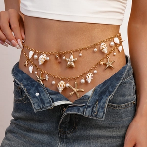 Close-up of double-layer gold waist chain with starfish, shell and pearl charms