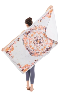 Detail of soft microfiber beach towel showing bohemian mandala pattern and lightweight fabric