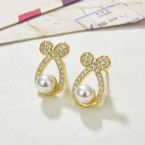 Elegant gold bow earrings with white pearls and sparkling cubic zirconia stones