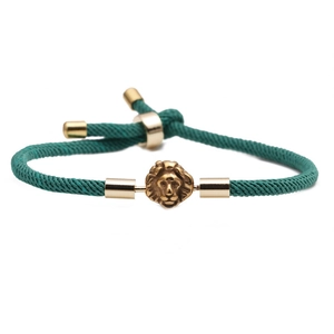 Adjustable green Milan rope bracelet with a gold lion head charm for men and women