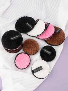 Detail of round microfiber makeup sponges in black, white, and pink with clean sponge strap