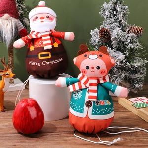 Detail of plush Santa and reindeer drawstring bags with Merry Christmas festive printing