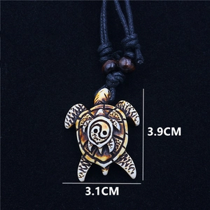 Yin Yang sea turtle pendant necklace made of resin with black woven cord and wood beads