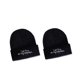Black knitted beanie hat with white embroidery text I got here on my unicorn