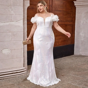 Detail of white sequin plus size evening gown with mermaid hem and ruffles